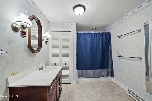 a bedroom with a bed and a fireplace