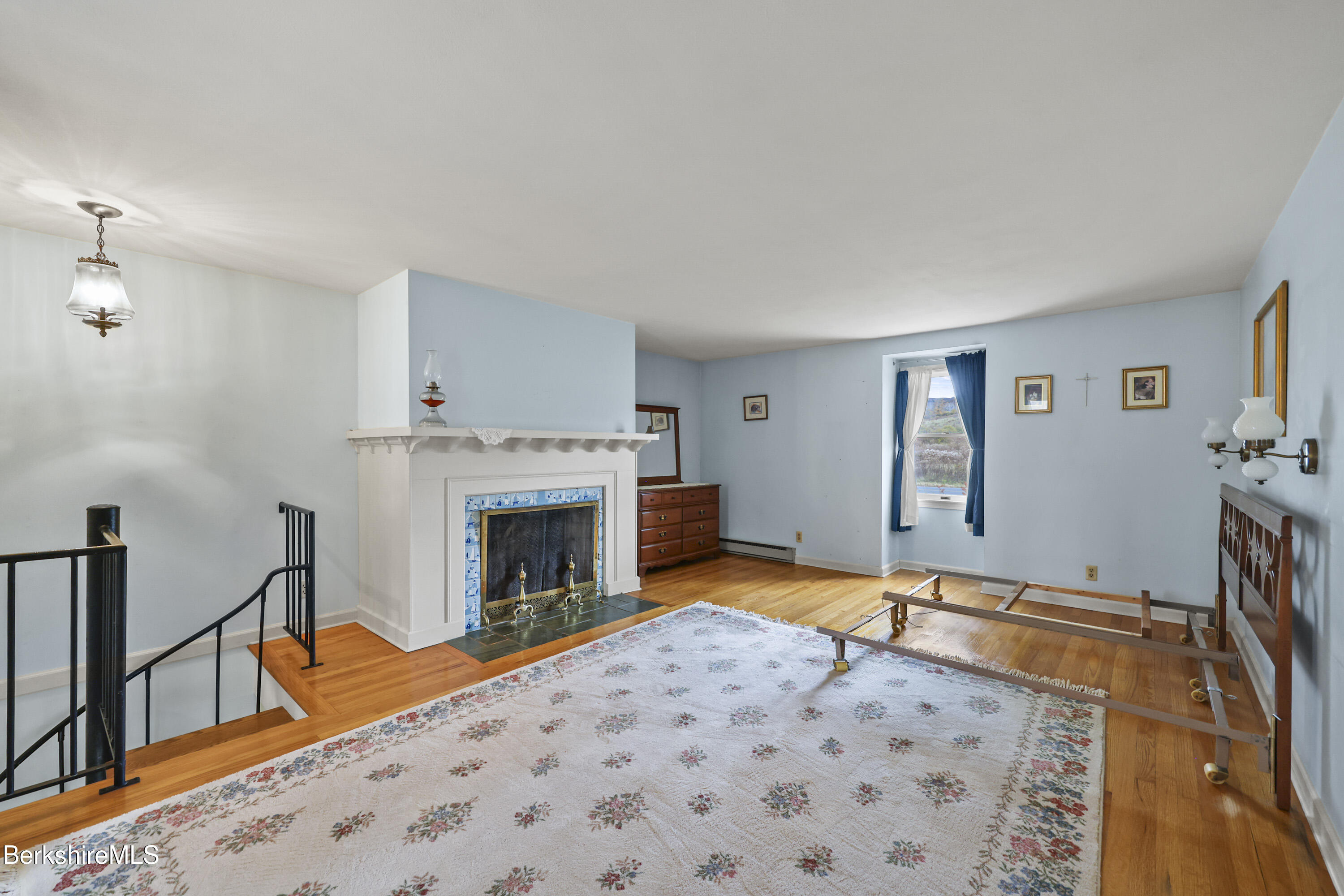 1772 Swamp Road Richmond, MA 01254 - Photo 34 of 62 a bedroom with a bed and a fireplace