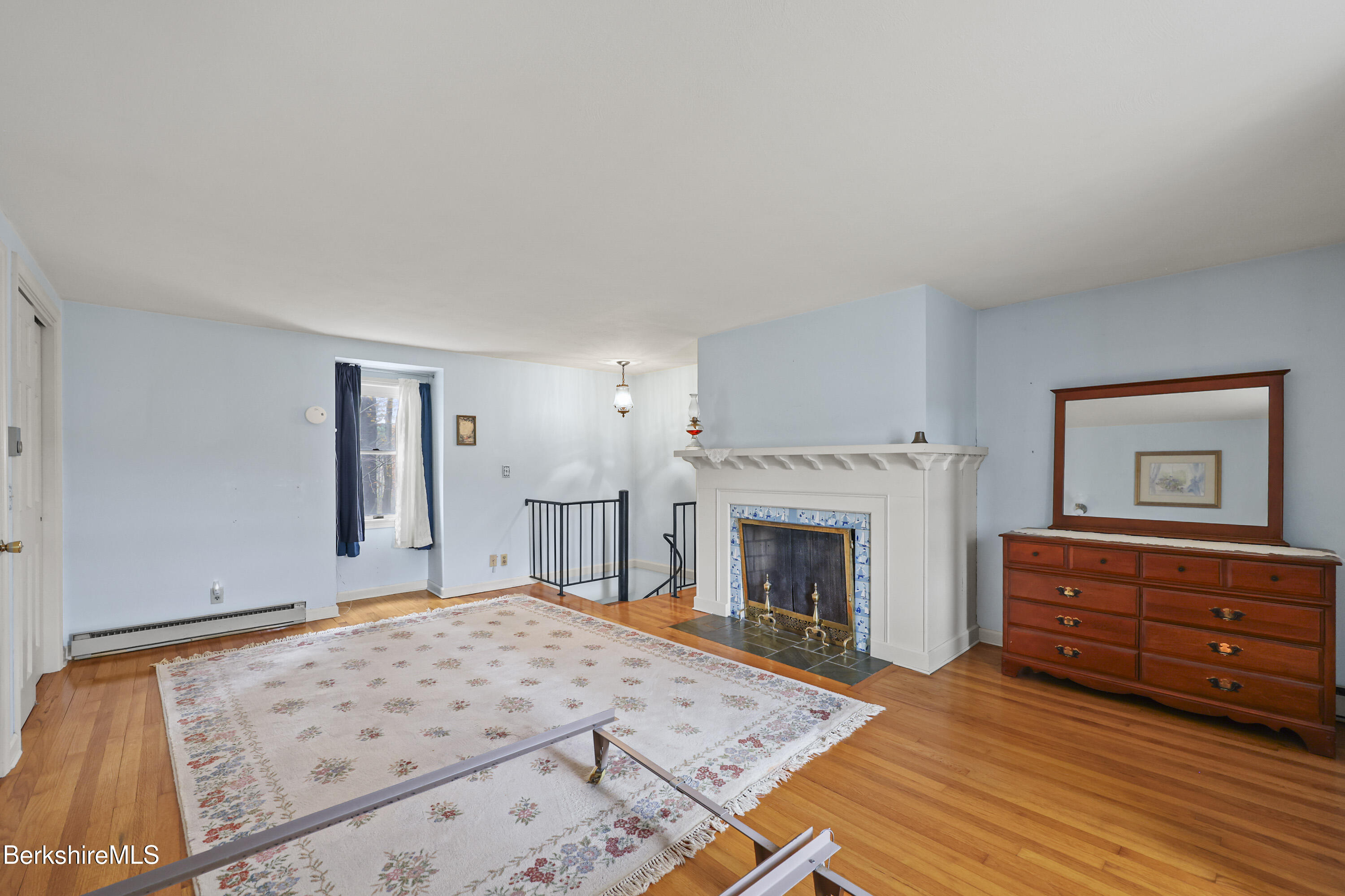 1772 Swamp Road Richmond, MA 01254 - Photo 37 of 62 a bedroom with a bed and a fireplace