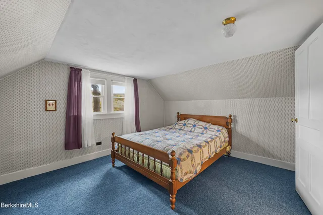 a bathroom with a sink vanity mirror and toilet