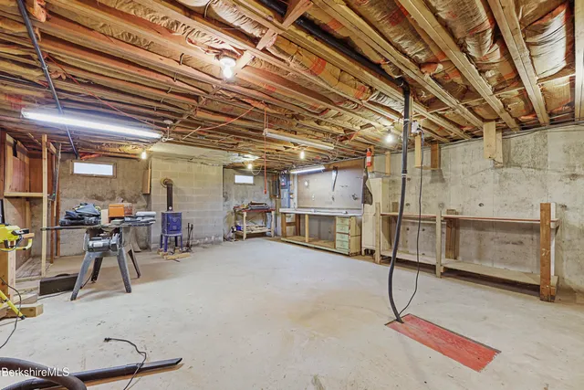 a front view of a house with a garden and tree