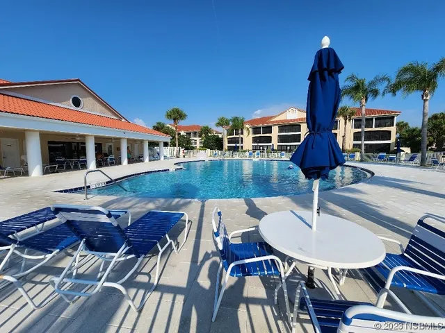 a view of a patio with table and chairs with wooden floor and plants