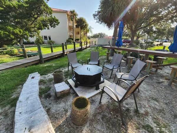 a view of a backyard with sitting area
