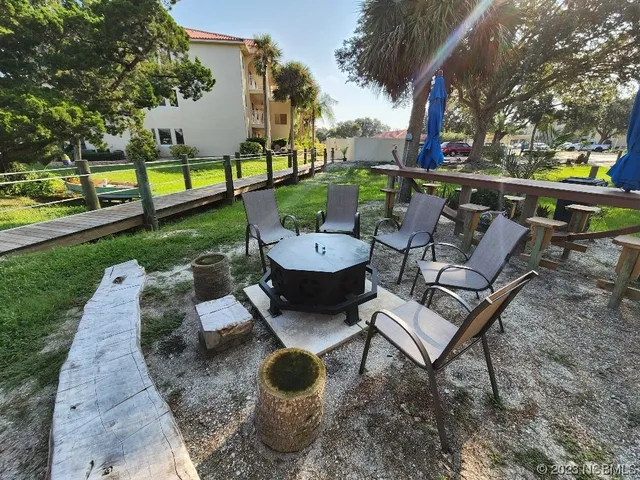a view of a backyard with sitting area
