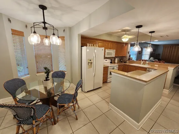 a kitchen that has a table and chairs in it