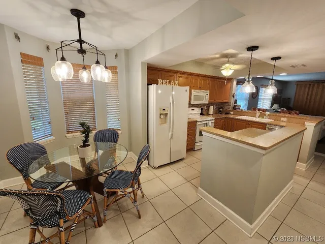 a kitchen that has a table and chairs in it