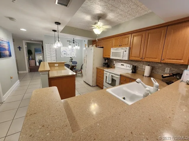 a kitchen with refrigerator and cabinets