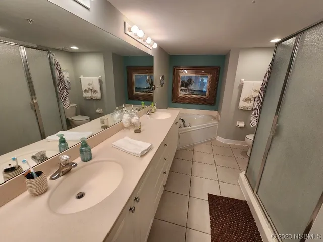 a spacious bathroom with a double vanity sink a mirror and a shower