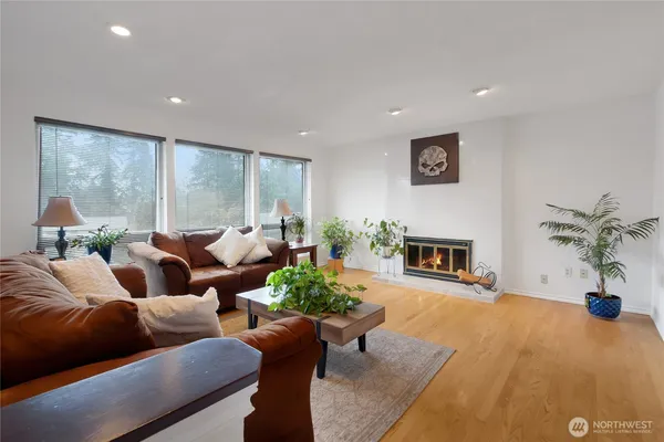 a living room with furniture potted plant and a fireplace