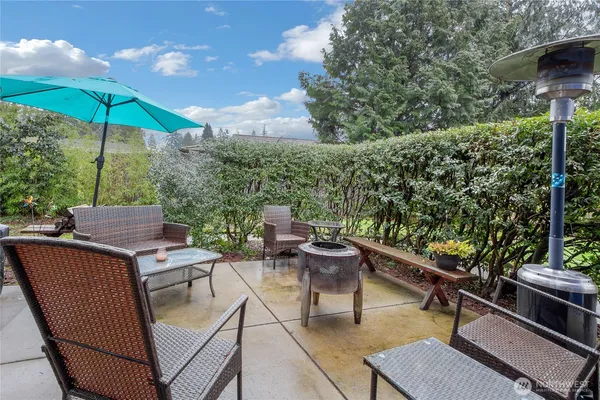 an outdoor sitting area with furniture and wooden floor