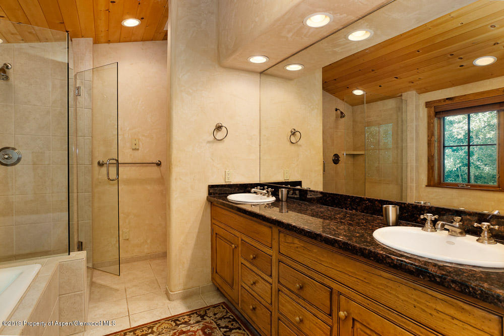43 Altamira Ranch Road Basalt, CO 81621 - Photo 14 of 29 a bathroom with a granite countertop sink a mirror and a shower