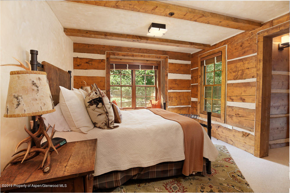 43 Altamira Ranch Road Basalt, CO 81621 - Photo 15 of 29 a bedroom with a bed and wooden floor