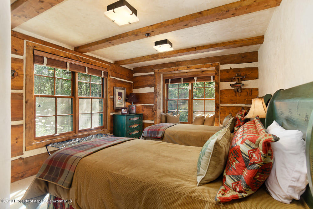43 Altamira Ranch Road Basalt, CO 81621 - Photo 17 of 29 a bed sitting in a bedroom next to a window