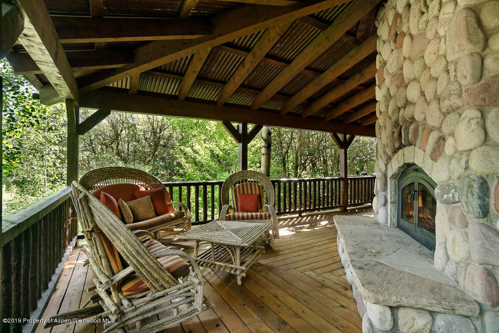 43 Altamira Ranch Road Basalt, CO 81621 - Photo 20 of 29 a view of a patio with a table chairs and a fireplace