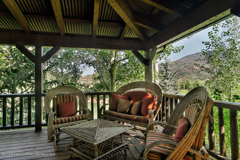 43 Altamira Ranch Road Basalt, CO 81621 - Photo 21 of 29 a patio with wooden floor a yard a table and chairs
