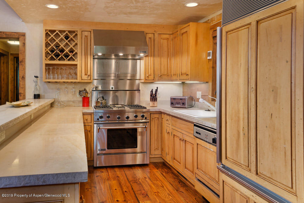 43 Altamira Ranch Road Basalt, CO 81621 - Photo 9 of 29 a kitchen with stainless steel appliances a stove a sink and a refrigerator with wooden floor
