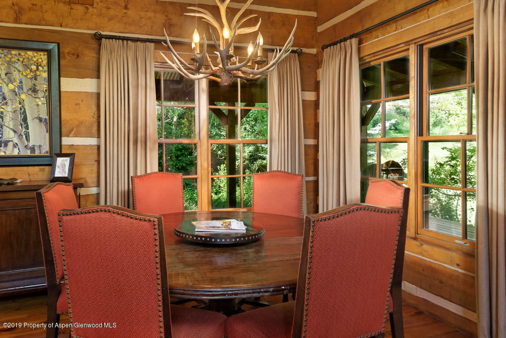 43 Altamira Ranch Road Basalt, CO 81621 - Photo 10 of 29 a view of a dining room with furniture large windows and wooden floor