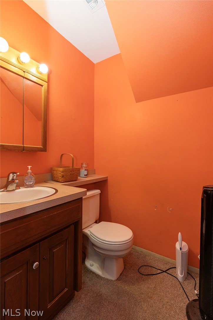 762 Abbe Road North Elyria, OH 44035 - Photo 23 of 30 Compact bathroom featuring a single vanity with a laminate countertop, an integrated sink, and a wood-finish cabinet