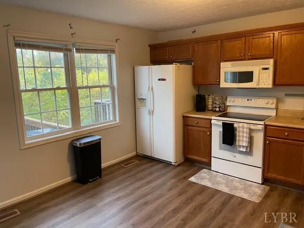 a kitchen with stainless steel appliances a stove a sink and a refrigerator
