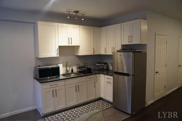 a kitchen with stainless steel appliances a refrigerator sink and cabinets