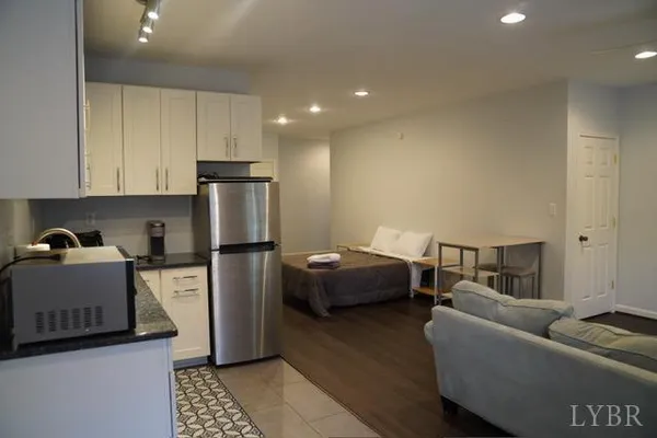 a kitchen with stainless steel appliances granite countertop a refrigerator sink and stove