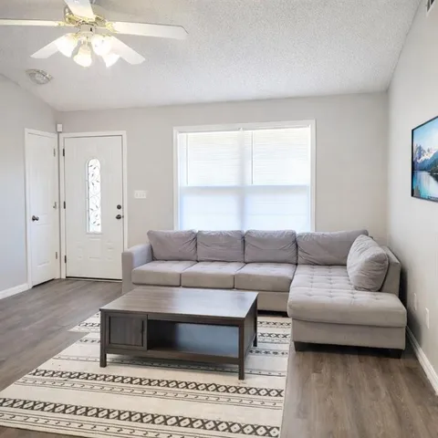 a living room with furniture and a window