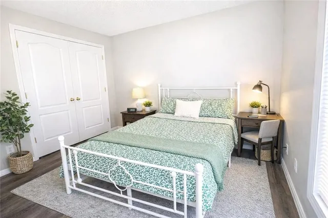 a bedroom with a bed and a potted plant