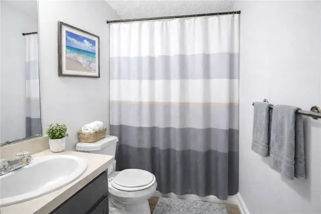 a bathroom with a sink toilet and mirror