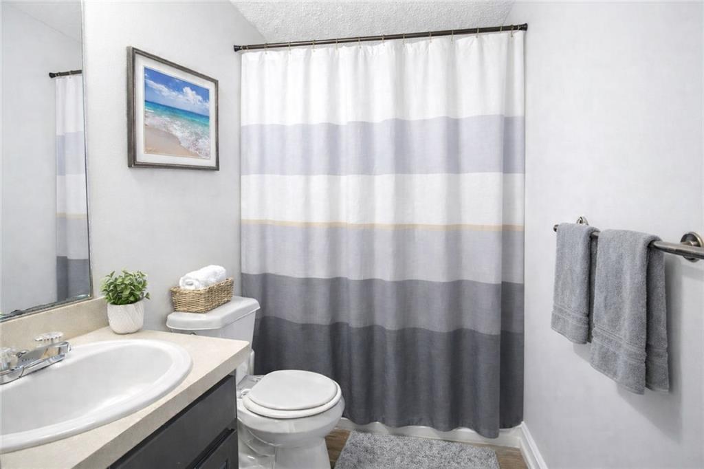 10348 Commons Crossing Jonesboro, GA 30238 - Photo 5 of 8 a bathroom with a sink toilet and mirror