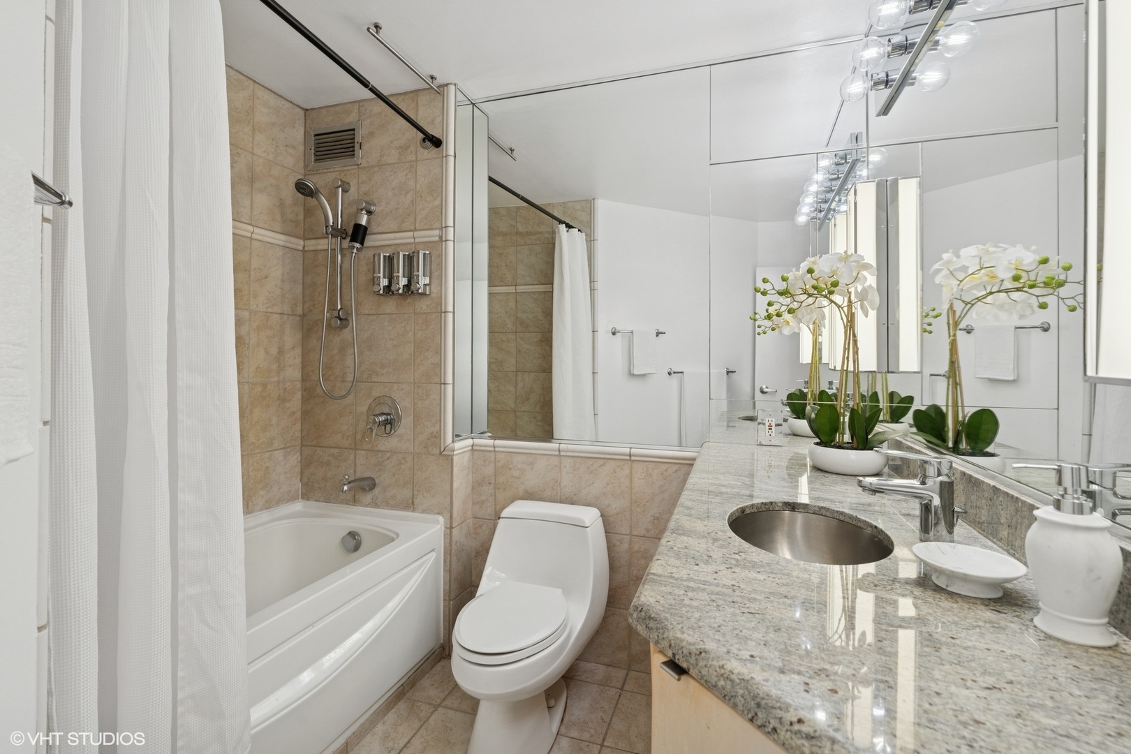 401 East Ontario Street, Unit 809 Chicago, IL 60611 - Photo 14 of 23 a bathroom with a granite countertop sink a toilet and shower