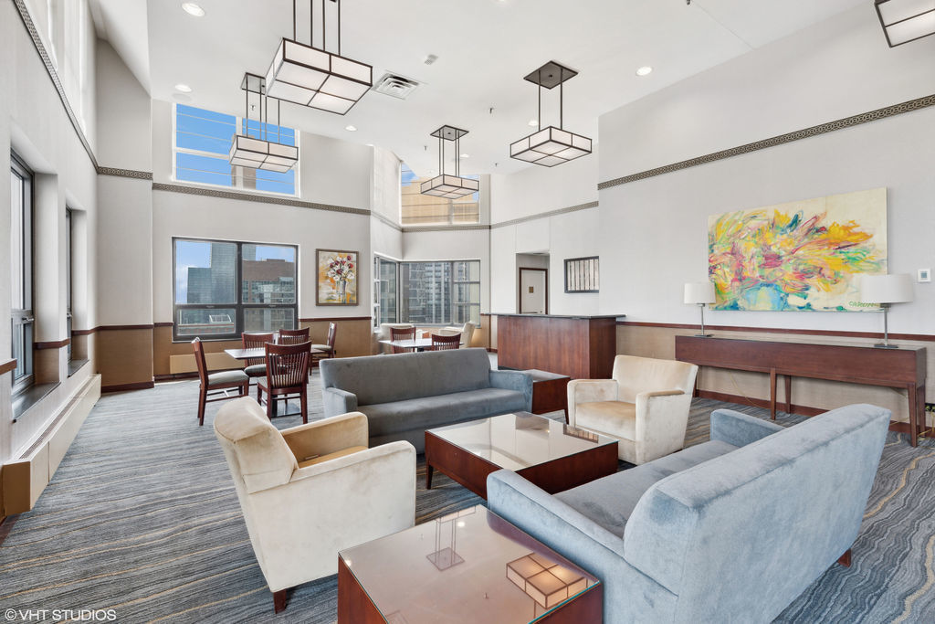 401 East Ontario Street, Unit 809 Chicago, IL 60611 - Photo 23 of 23 a living room with lots of furniture and a chandelier