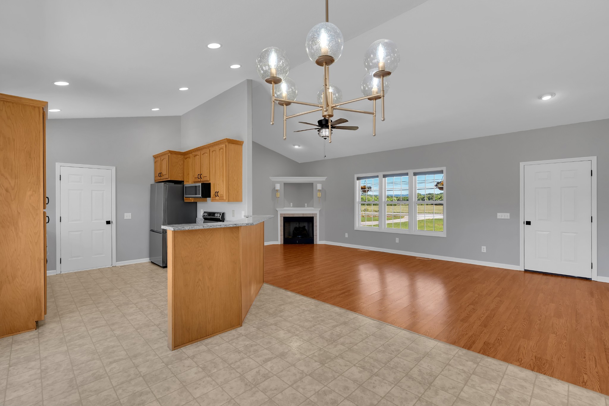 3896 Lynchburg Road Winchester, TN 37398 - Photo 13 of 57 an open kitchen with fireplace and wooden floor