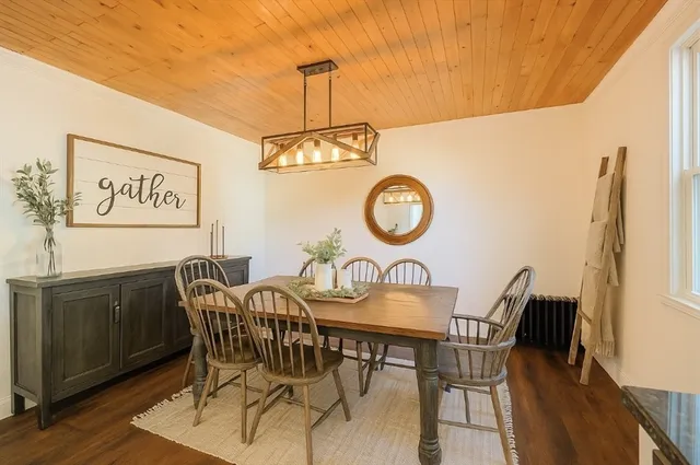 a view of a room with wooden floor and chandelier