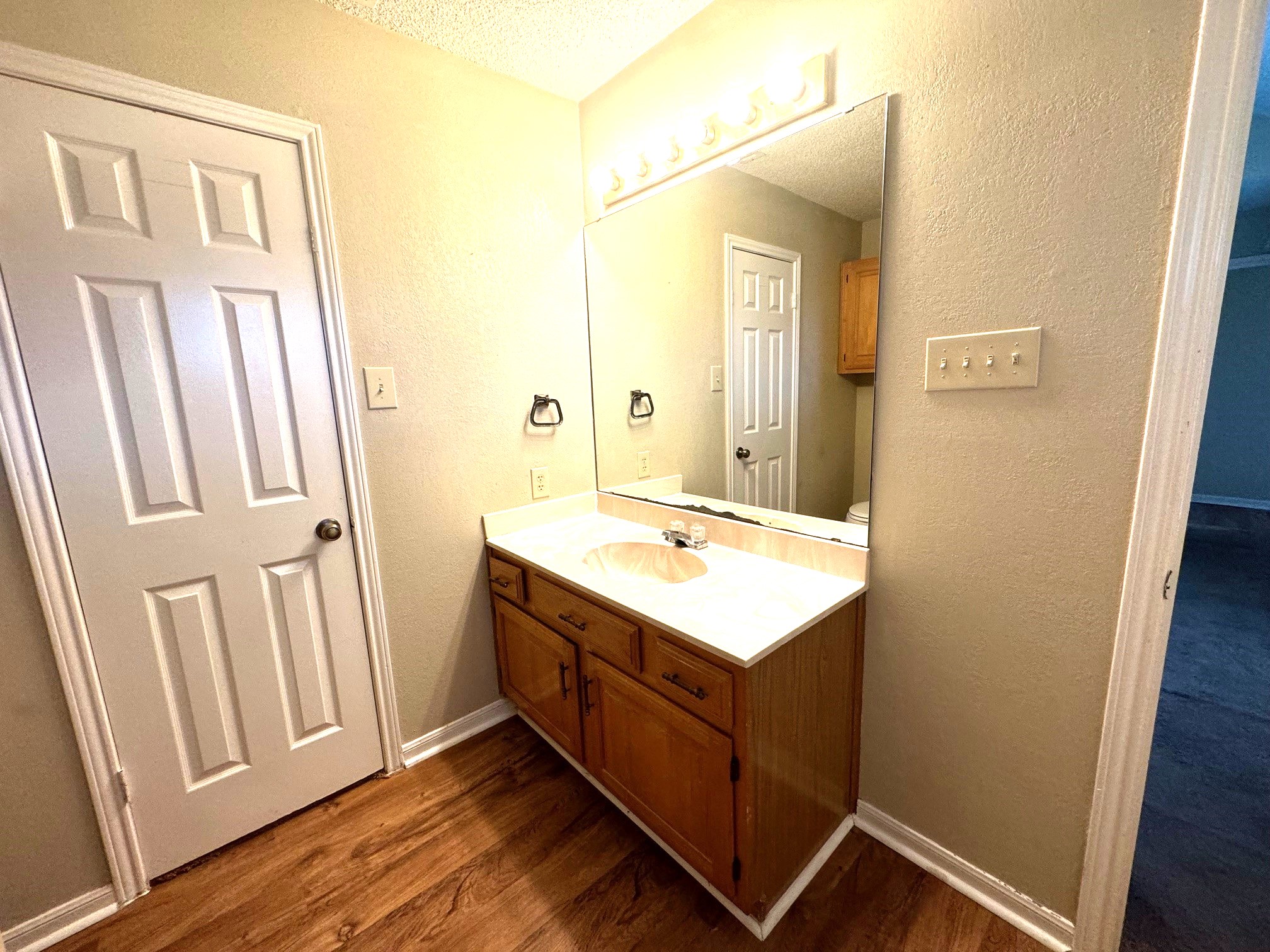 117 Quail Cove, Unit A Lockhart, TX 78644 - Photo 12 of 12 a bathroom with a sink a mirror and a vanity