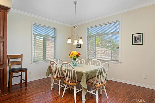 a view of a dining room with furniture wooden floor and a chandelier