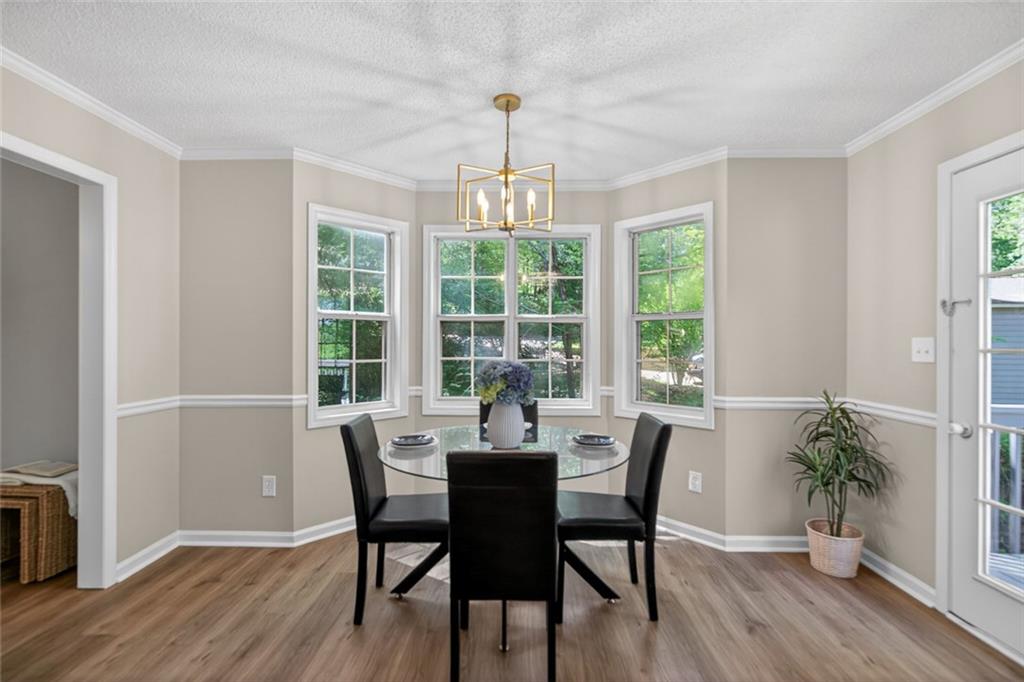 190 Killian Street Canton, GA 30114 - Photo 11 of 44 a dining room with furniture window wooden floor