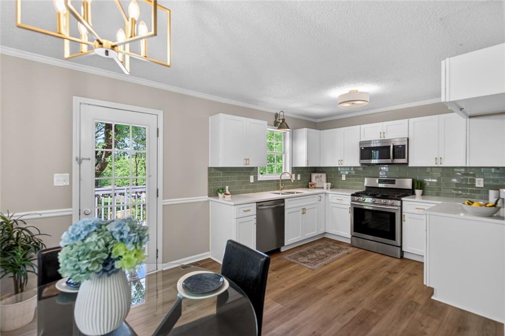 190 Killian Street Canton, GA 30114 - Photo 13 of 44 a kitchen with a white stove top oven and sink