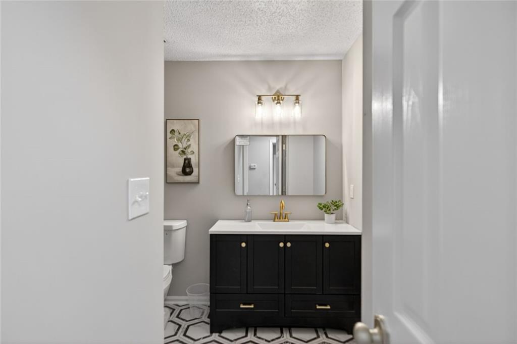 190 Killian Street Canton, GA 30114 - Photo 16 of 44 a bathroom with a sink and a mirror