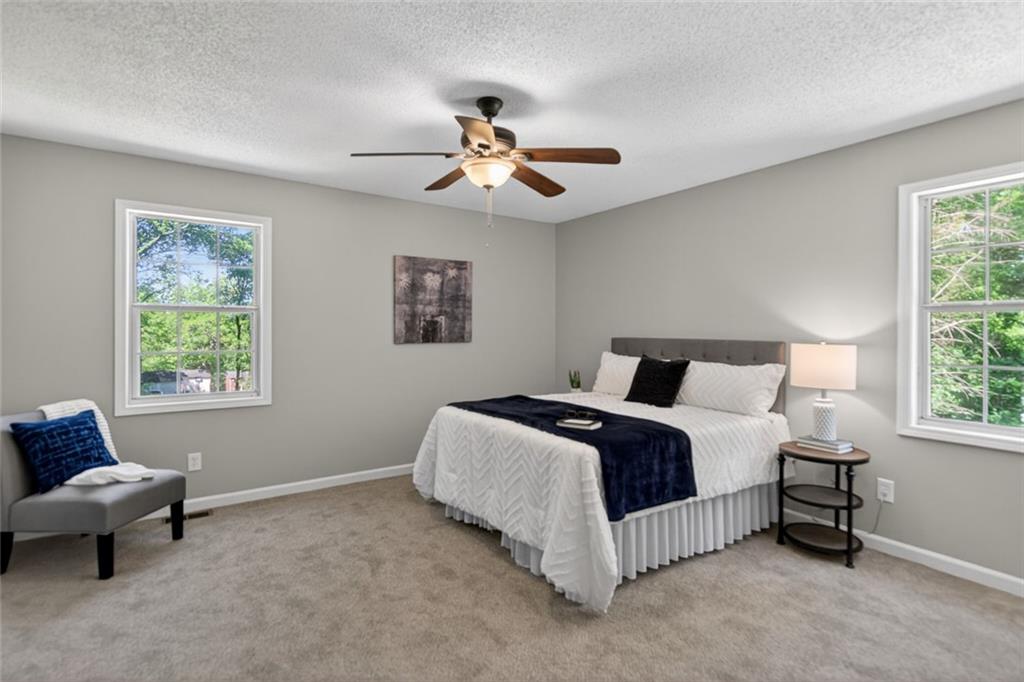 190 Killian Street Canton, GA 30114 - Photo 21 of 44 a spacious bedroom with a bed and a window
