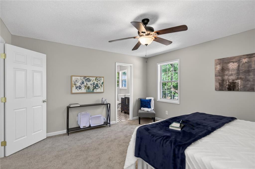 190 Killian Street Canton, GA 30114 - Photo 23 of 44 a bedroom with a bed and a chandelier