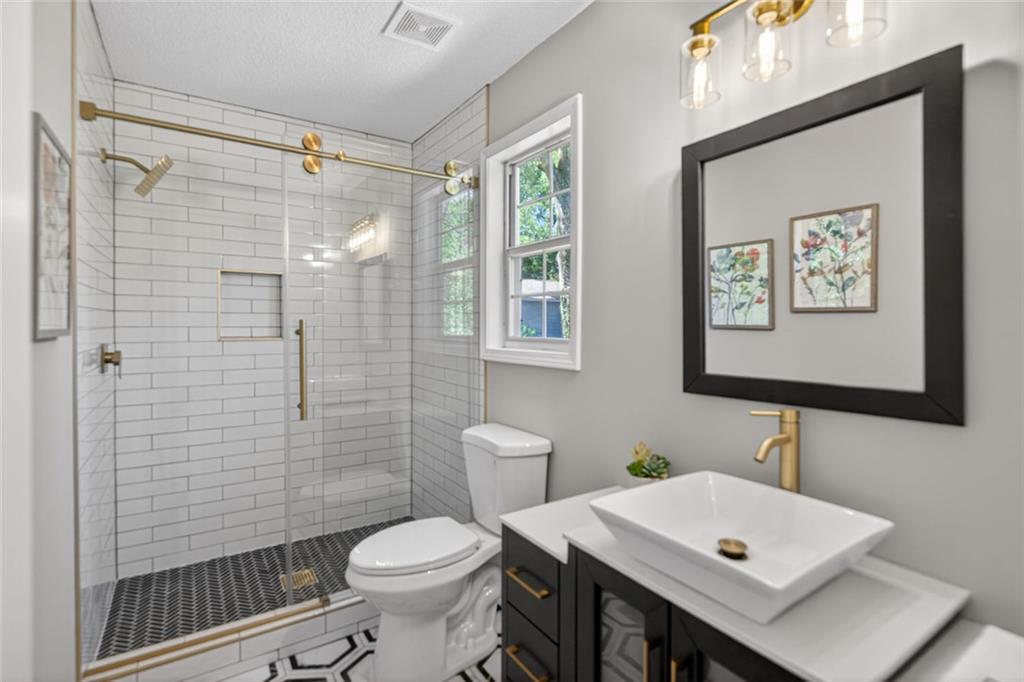 190 Killian Street Canton, GA 30114 - Photo 24 of 44 a bathroom with a sink a toilet and shower