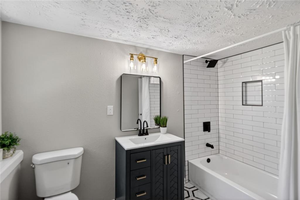 190 Killian Street Canton, GA 30114 - Photo 30 of 44 a bathroom with a bathtub shower sink mirror and toilet