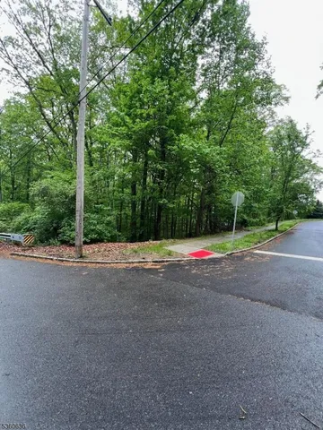 a view of a road with a house in the background