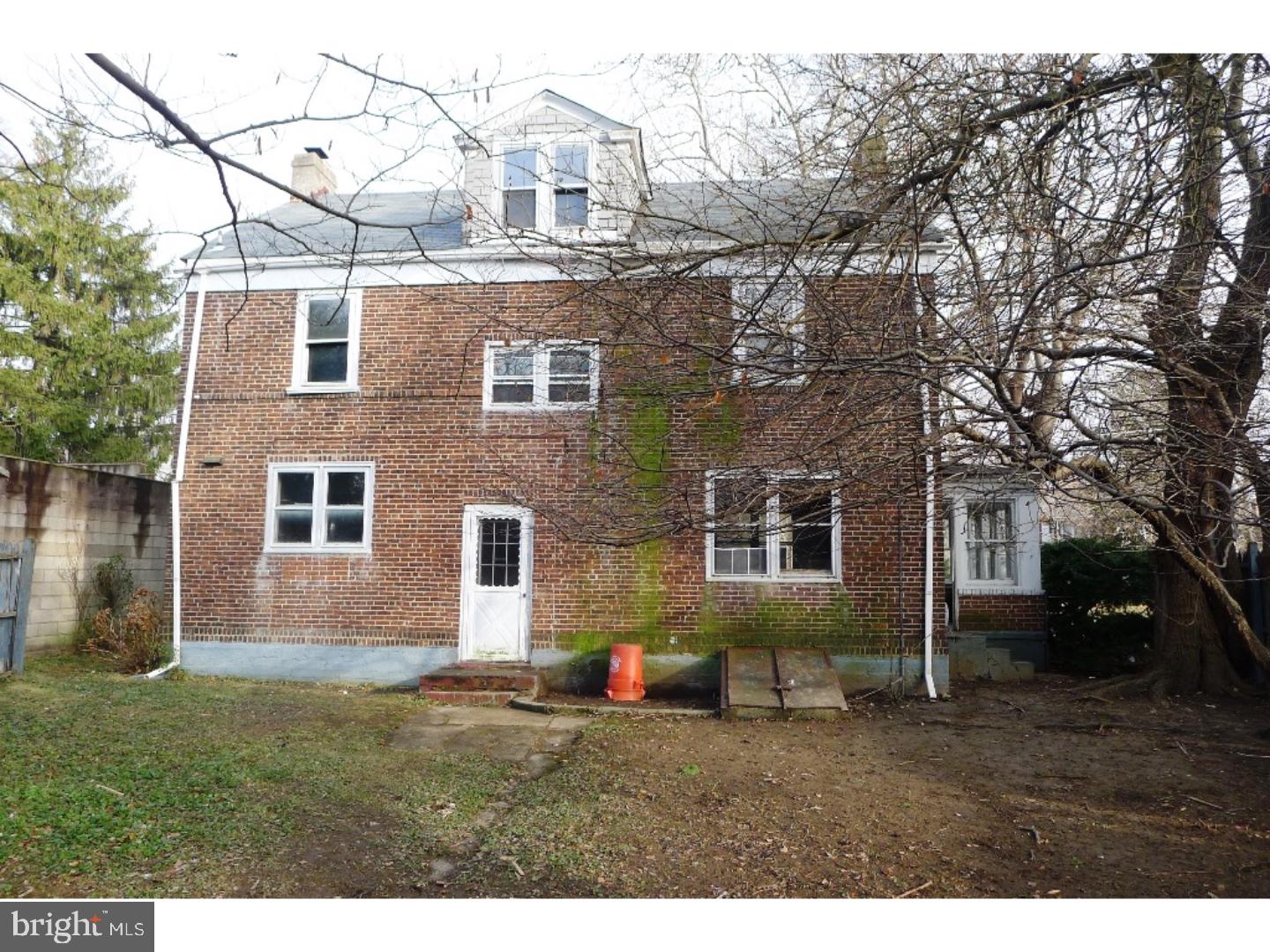 3129 South Atlanta Road Camden, NJ 08104 - Photo 5 of 13 a view of a yard in front of a brick house with large windows