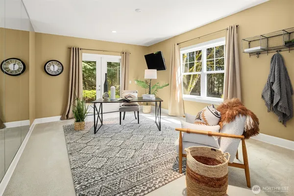 a living room with furniture a fireplace and a large window