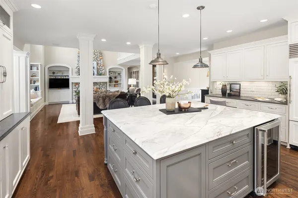 a kitchen with a large window and white cabinets