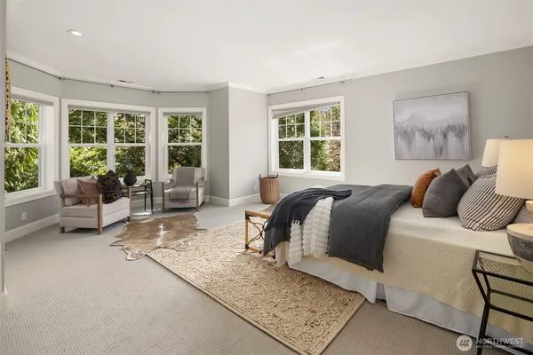 a bedroom with a bed a fireplace and a large window