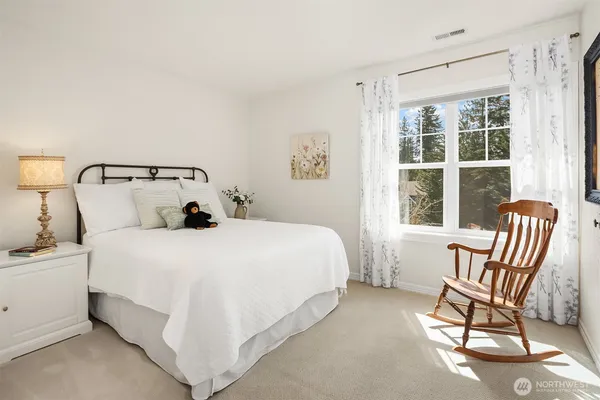 a bathroom with double sink and a mirror