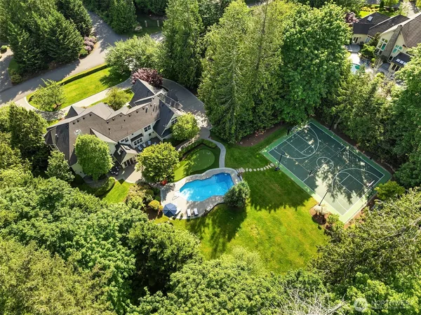 an aerial view of residential house with outdoor space and swimming pool