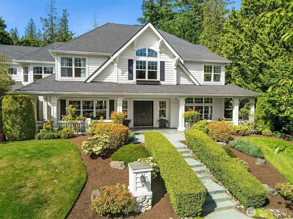 a front view of a house with garden and porch